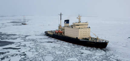 This picture depicts the ice sheet on the Arctic Ocean on the Northwest Passage on Arctic Route that shows the Arctic Climate Change Impact, melting glaciars that cause difficulties during the trade in Arctic Region.